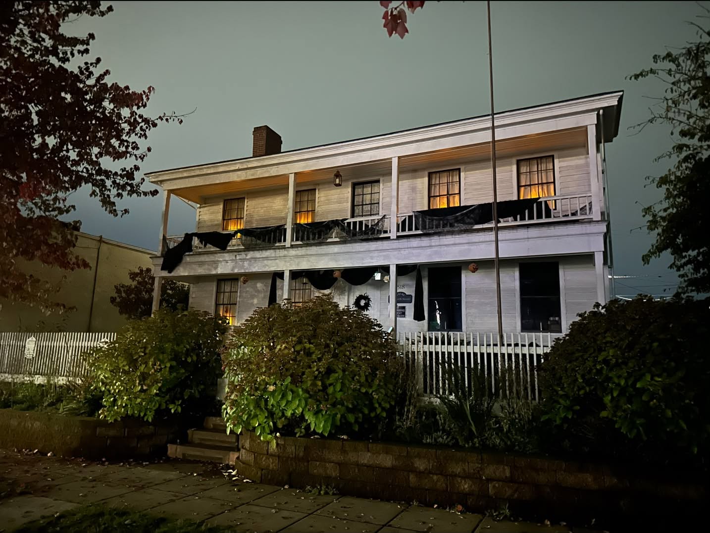 Monteith House Museum at night decorated for Halloween.